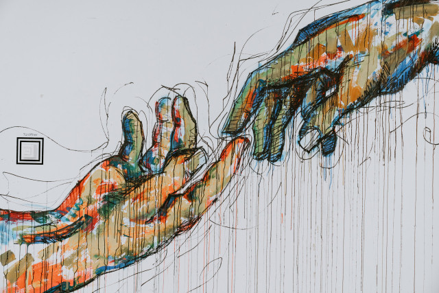 Two hands reaching at each other
